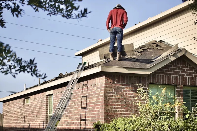 Professional roofer working on a residential roof in Lenhartsville